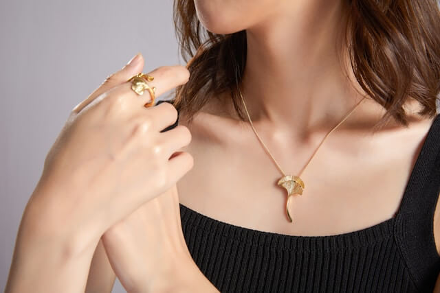 woman wearing gold jewelry necklace