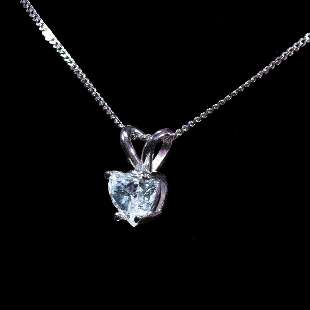 14K white gold pendant necklace featuring a 0.65 ct heart-shaped natural diamond in a classic solitaire setting with a matching white gold chain.