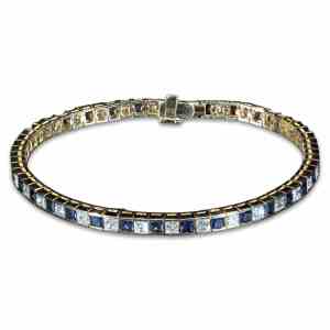 Luxury 18K yellow gold tennis bracelet featuring alternating natural princess-cut blue sapphires and brilliant-cut diamonds totaling 8.85 carats.