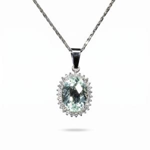Elegant 18K white gold pendant necklace featuring a natural oval-cut aquamarine surrounded by a halo of brilliant natural diamonds suspended from a matching white gold chain.
