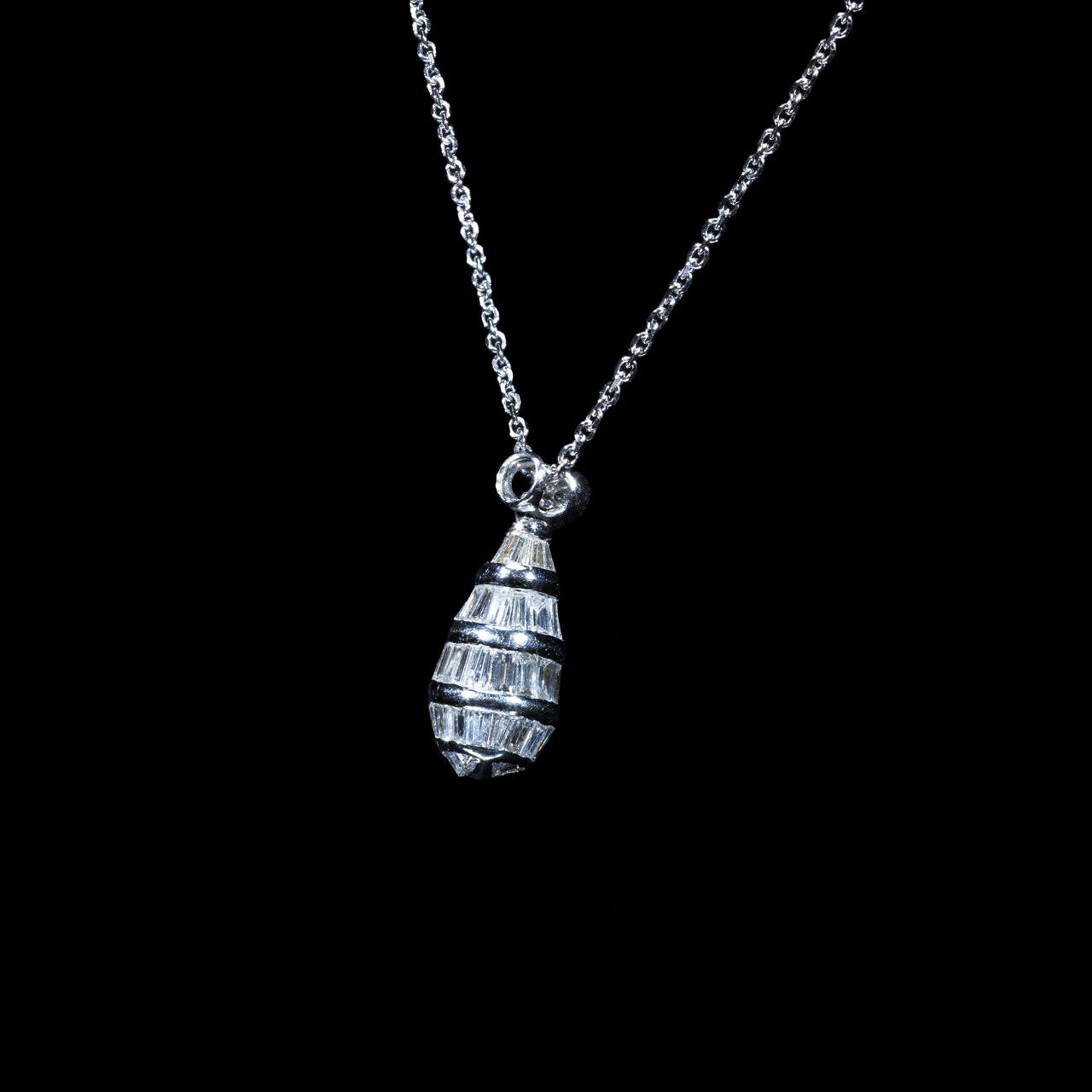 white gold pendant necklace featuring natural baguette-cut and round brilliant diamonds suspended from a matching white gold chain.