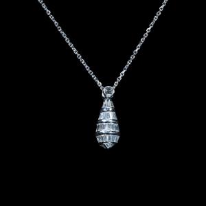 Elegant 18K white gold pendant necklace featuring natural baguette-cut and round brilliant diamonds suspended from a matching white gold chain.