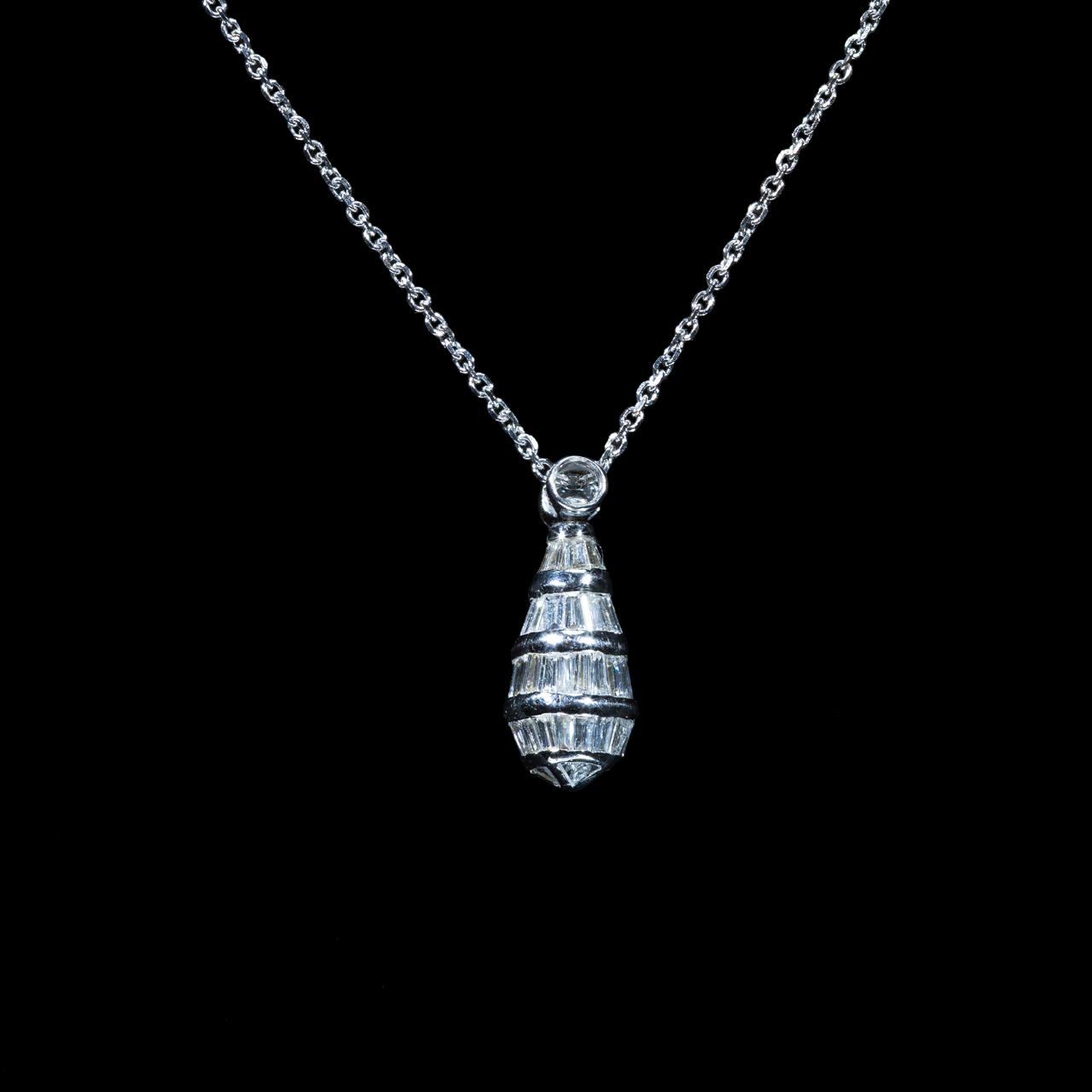 Elegant 18K white gold pendant necklace featuring natural baguette-cut and round brilliant diamonds suspended from a matching white gold chain.
