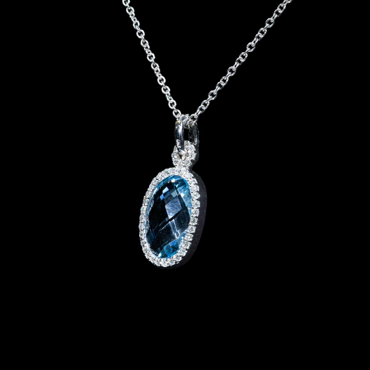 white gold pendant necklace featuring a natural oval blue topaz surrounded by a halo of brilliant-cut diamonds with a matching white gold chain.
