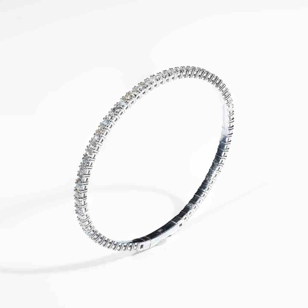 Elegant 18K white gold diamond bangle featuring 67 natural brilliant-cut diamonds totaling 2.26 carats.
