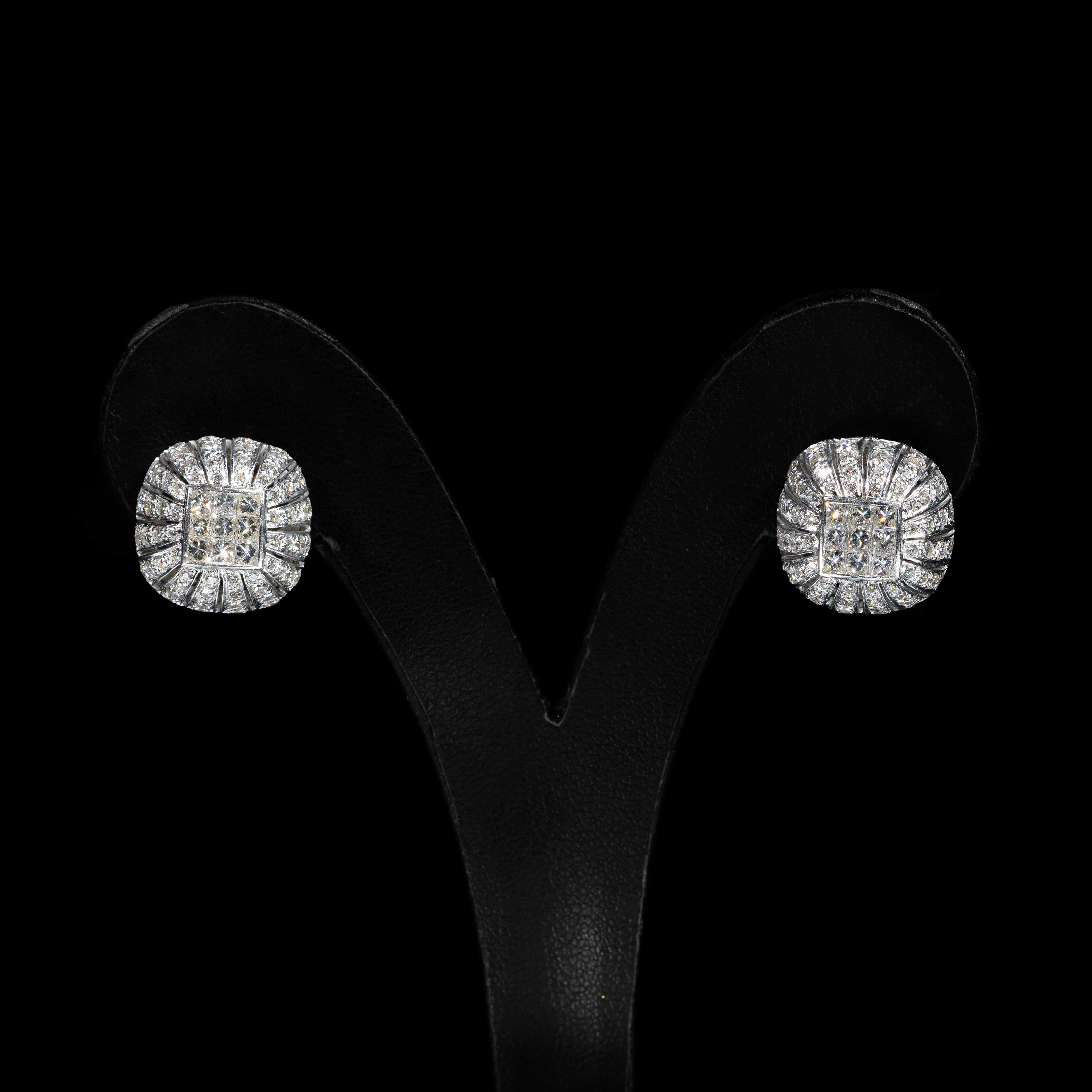 Luxury 18K white gold jewelry set featuring a matching diamond pendant with chain and stud earrings set with princess-cut and brilliant-cut natural diamonds.