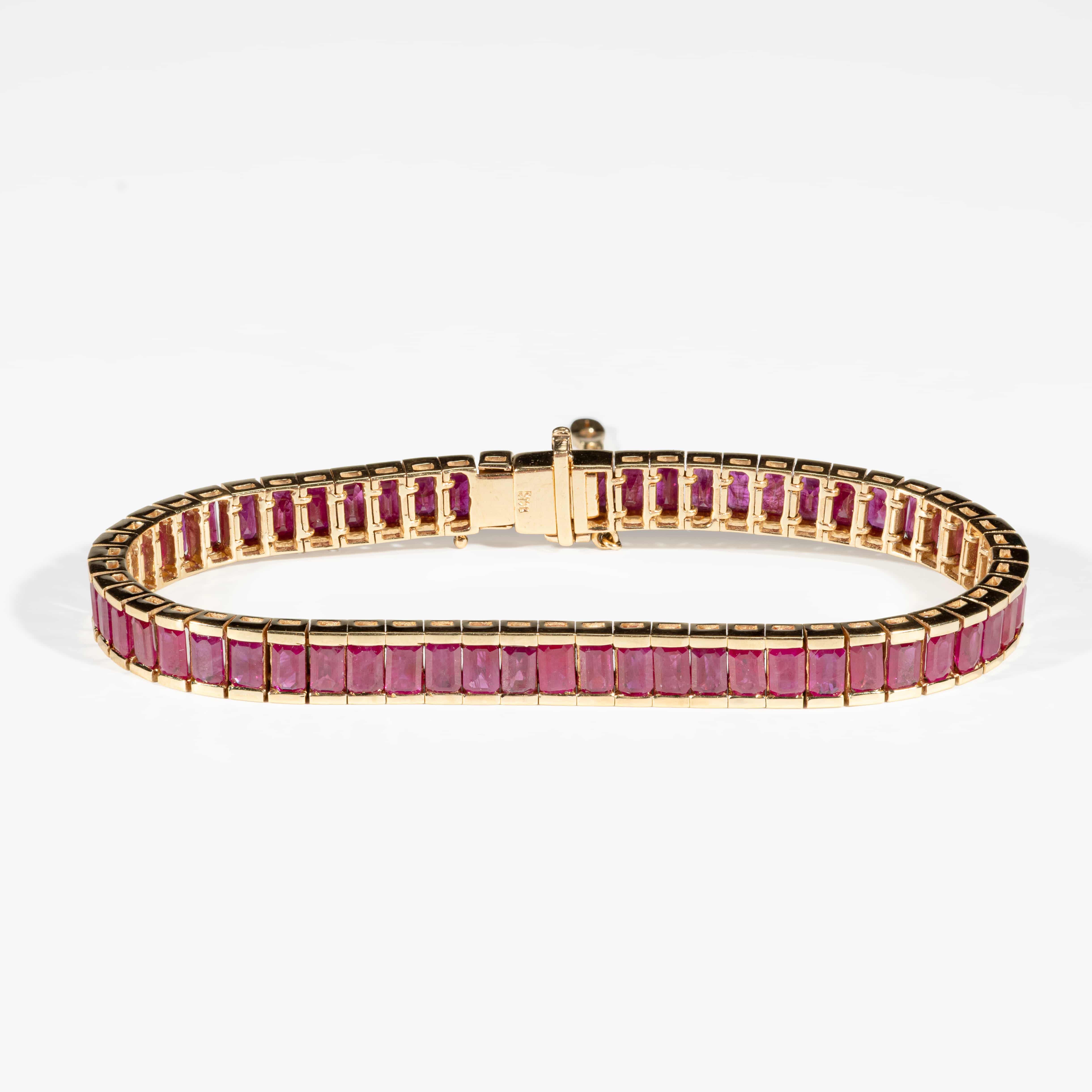 18K yellow gold tennis bracelet featuring natural step-cut Burmese rubies with GIA certification confirming Myanmar origin.