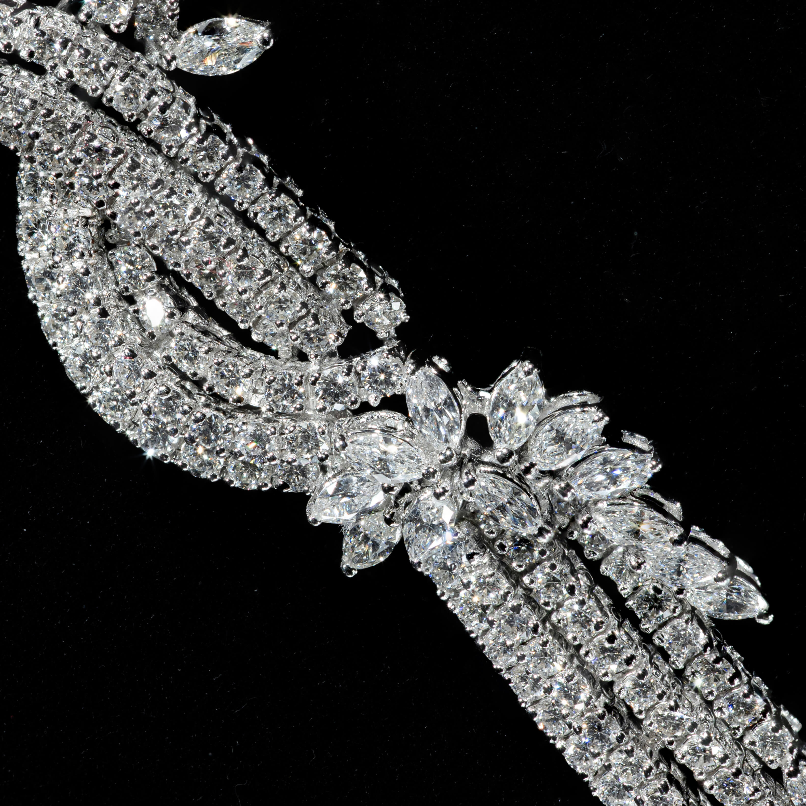 Luxury diamond statement necklace with cascading floral design in white gold finish closeup