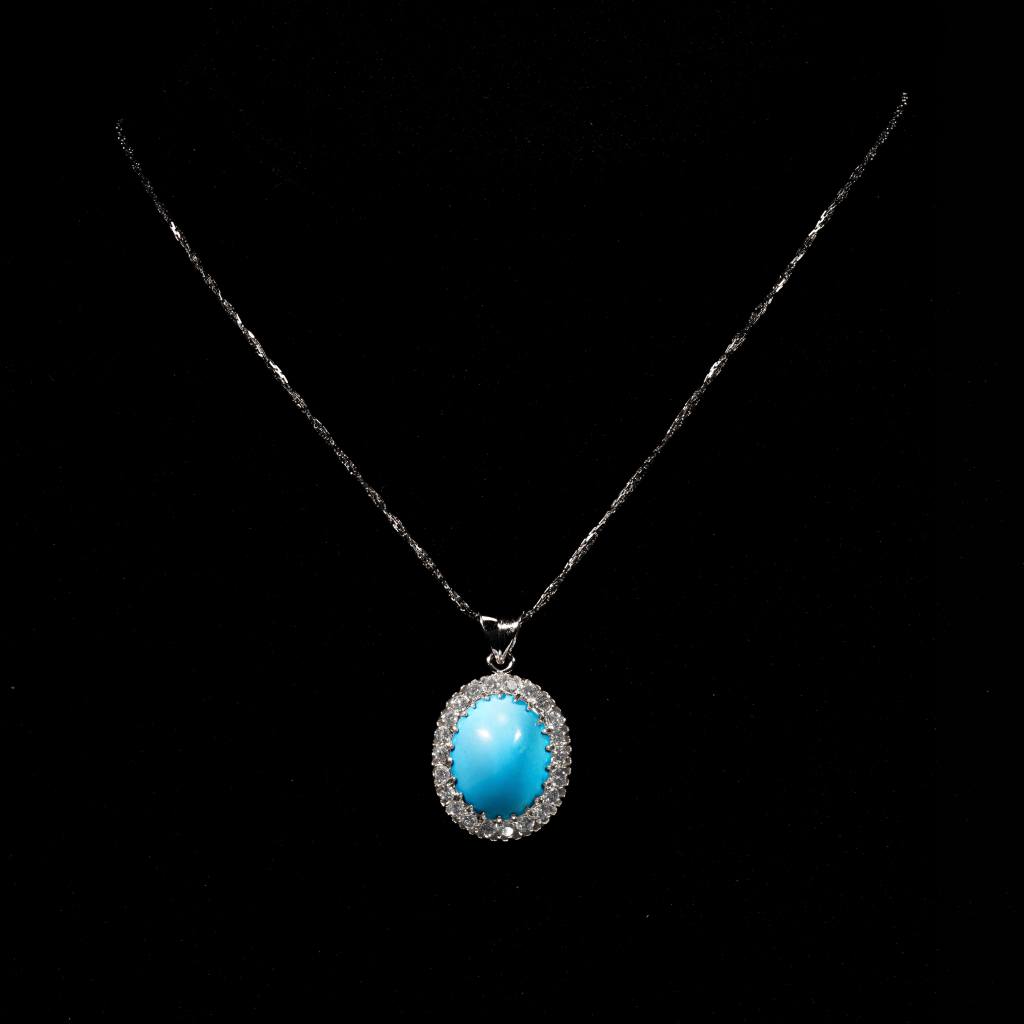 Celeste turquoise halo pendant woman necklace featuring an oval blue turquoise gemstone with sparkling halo