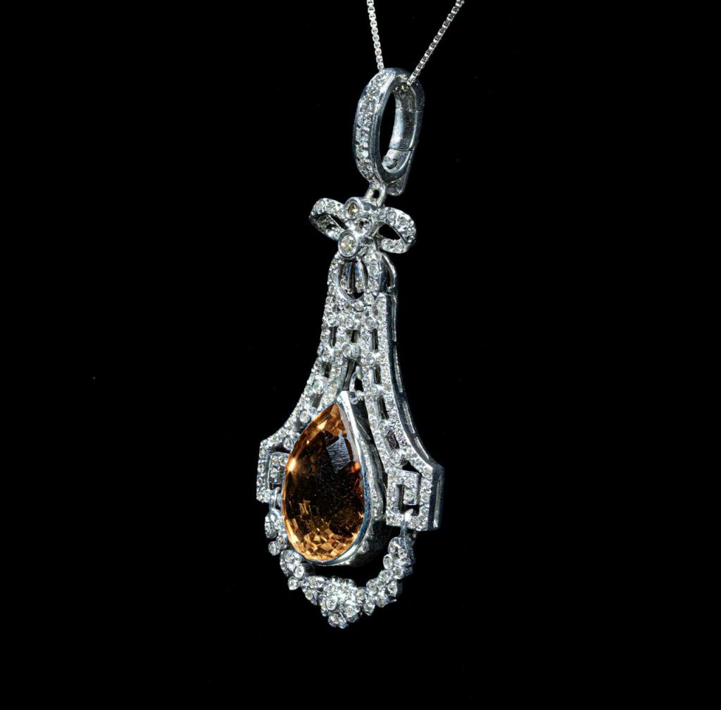 white gold pendant necklace featuring a pear-shaped natural citrine surrounded by brilliant-cut natural diamonds in an intricate vintage-inspired setting.