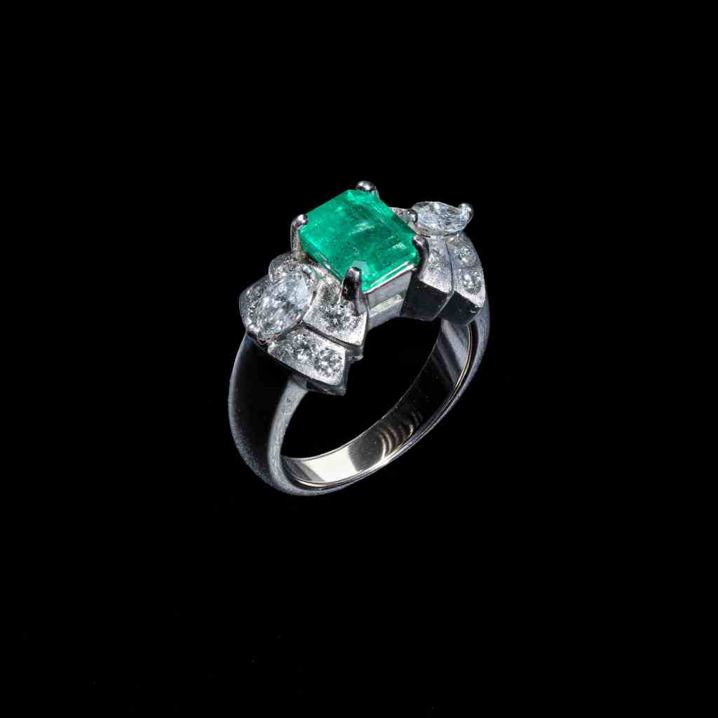 18K white gold ring featuring a 2.00 ct natural Colombian emerald accented by marquise-cut and round brilliant diamonds.
