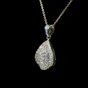 Elegant 18K yellow gold teardrop pendant necklace featuring 1.97 ct of natural round brilliant and baguette-cut diamonds suspended from a matching gold chain.
