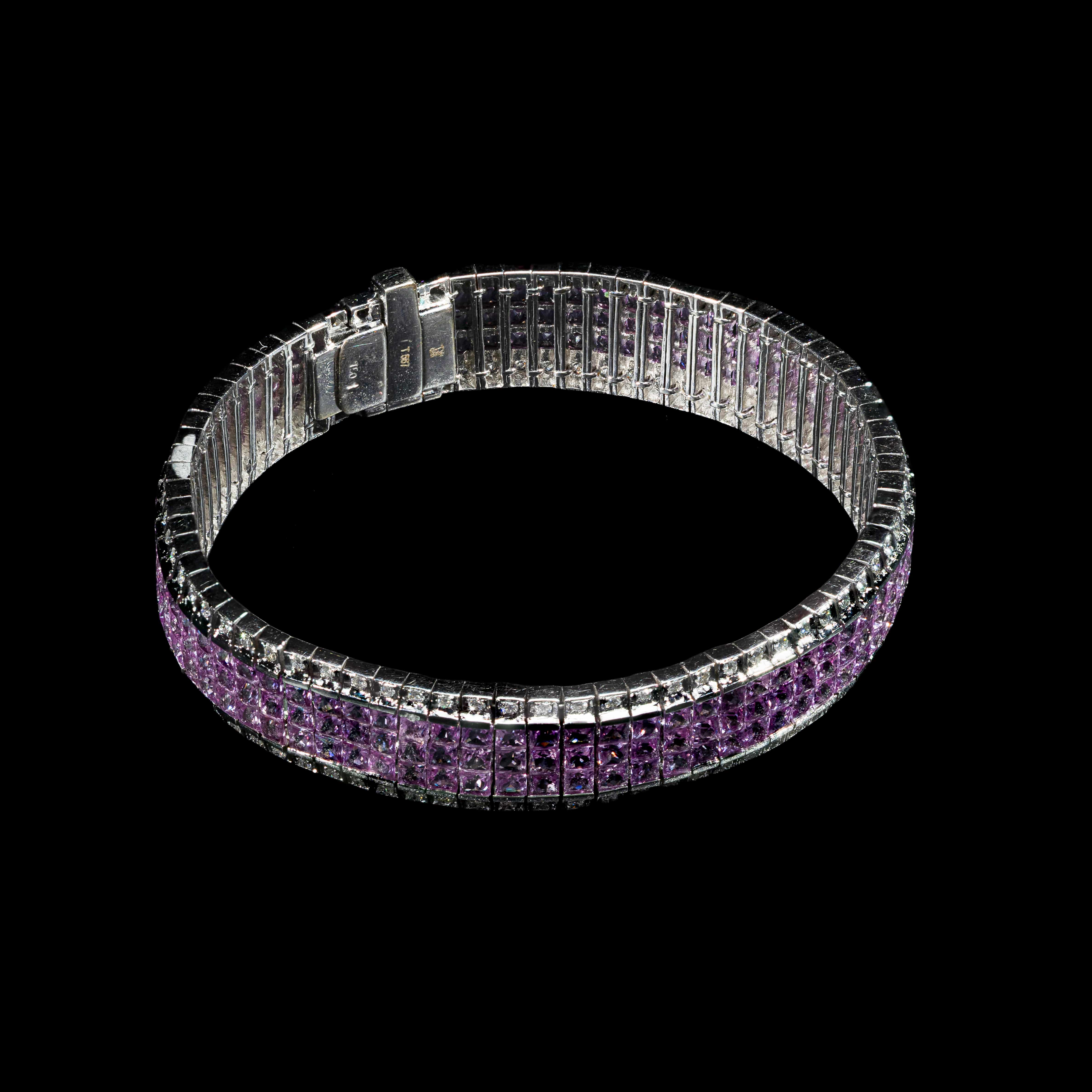 Luxury 18K white gold tennis bracelet featuring three rows of princess-cut natural pink sapphires, accented by natural diamonds.