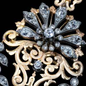 Antique gold and silver pendant brooch featuring Old Cut diamonds with a natural pearl drop in an ornate handcrafted design.