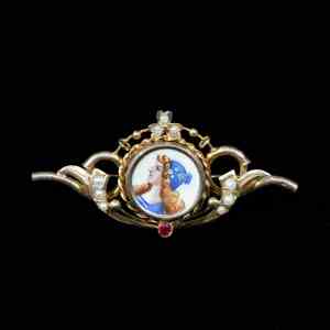 Victorian antique gold brooch featuring an original hand-painted porcelain miniature, natural seed pearls, and a ruby accent.