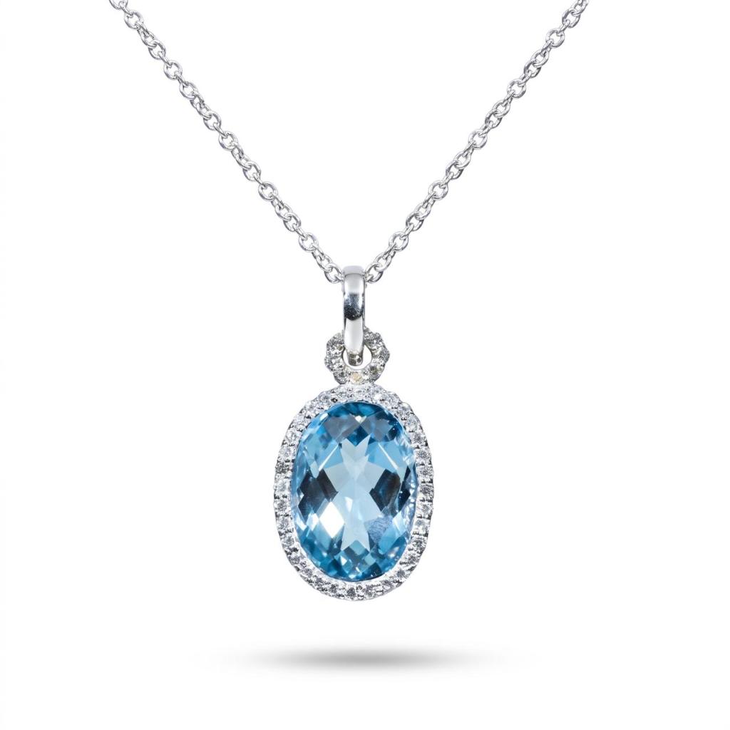 Elegant 18K white gold pendant necklace featuring a natural oval blue topaz surrounded by a halo of brilliant-cut diamonds with a matching white gold chain.