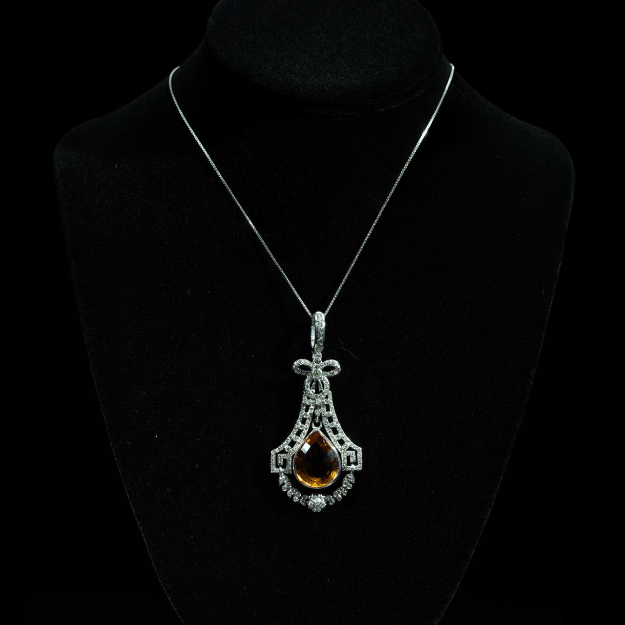 Elegant 18K white gold pendant necklace featuring a pear-shaped natural citrine surrounded by brilliant-cut natural diamonds.