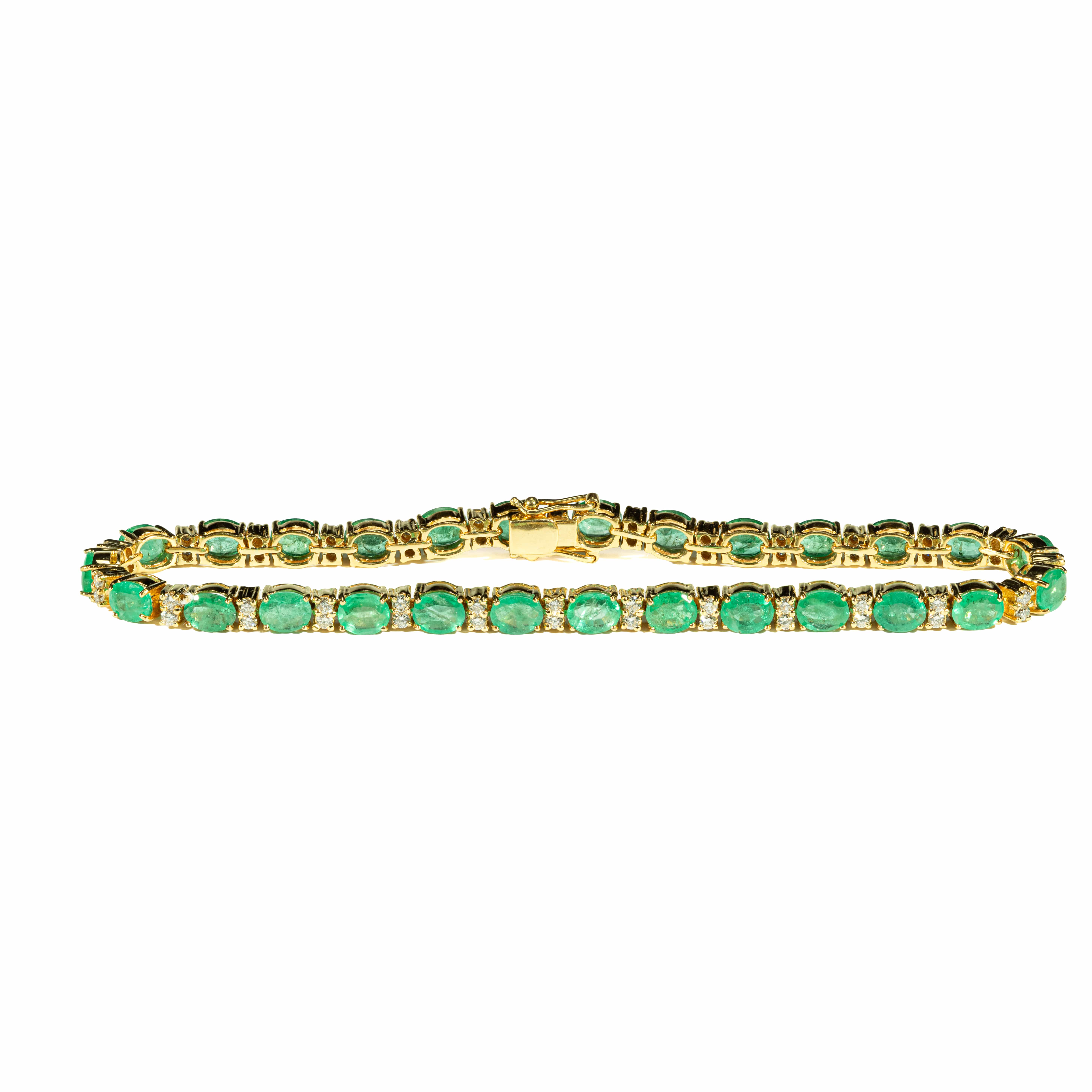 18K yellow gold tennis bracelet featuring natural oval-cut emeralds totaling 9.27 carats accented with brilliant-cut diamonds totaling 1.00 carat.