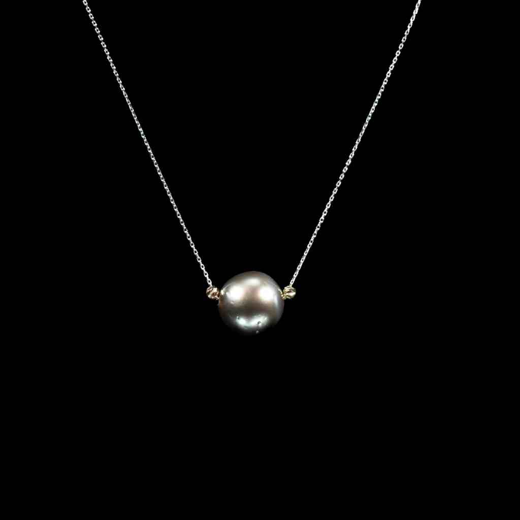 18K white gold and 14K yellow gold pendant necklace featuring a lustrous natural black freshwater pearl in a minimalist two-tone setting.
