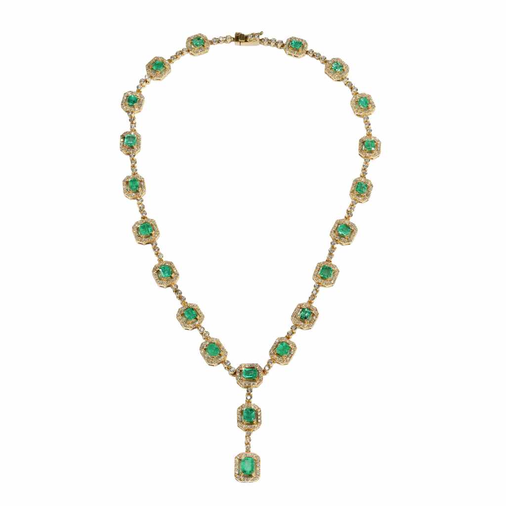 18K gold Colombian emerald and diamond necklace featuring graduated emeralds surrounded by brilliant diamonds