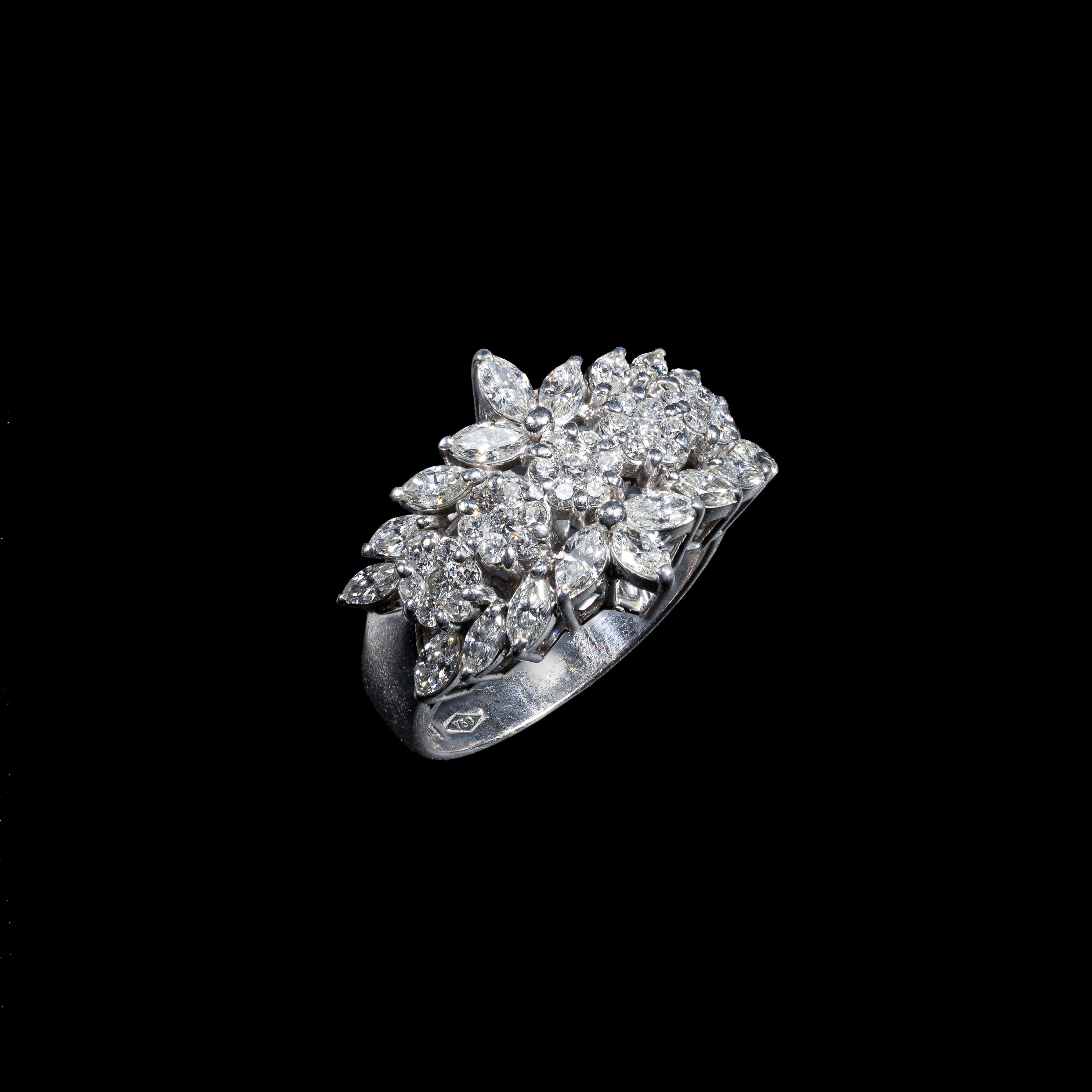 18K white gold floral ring featuring 1.50 carats of marquise diamonds and 0.57 carats of round diamonds.