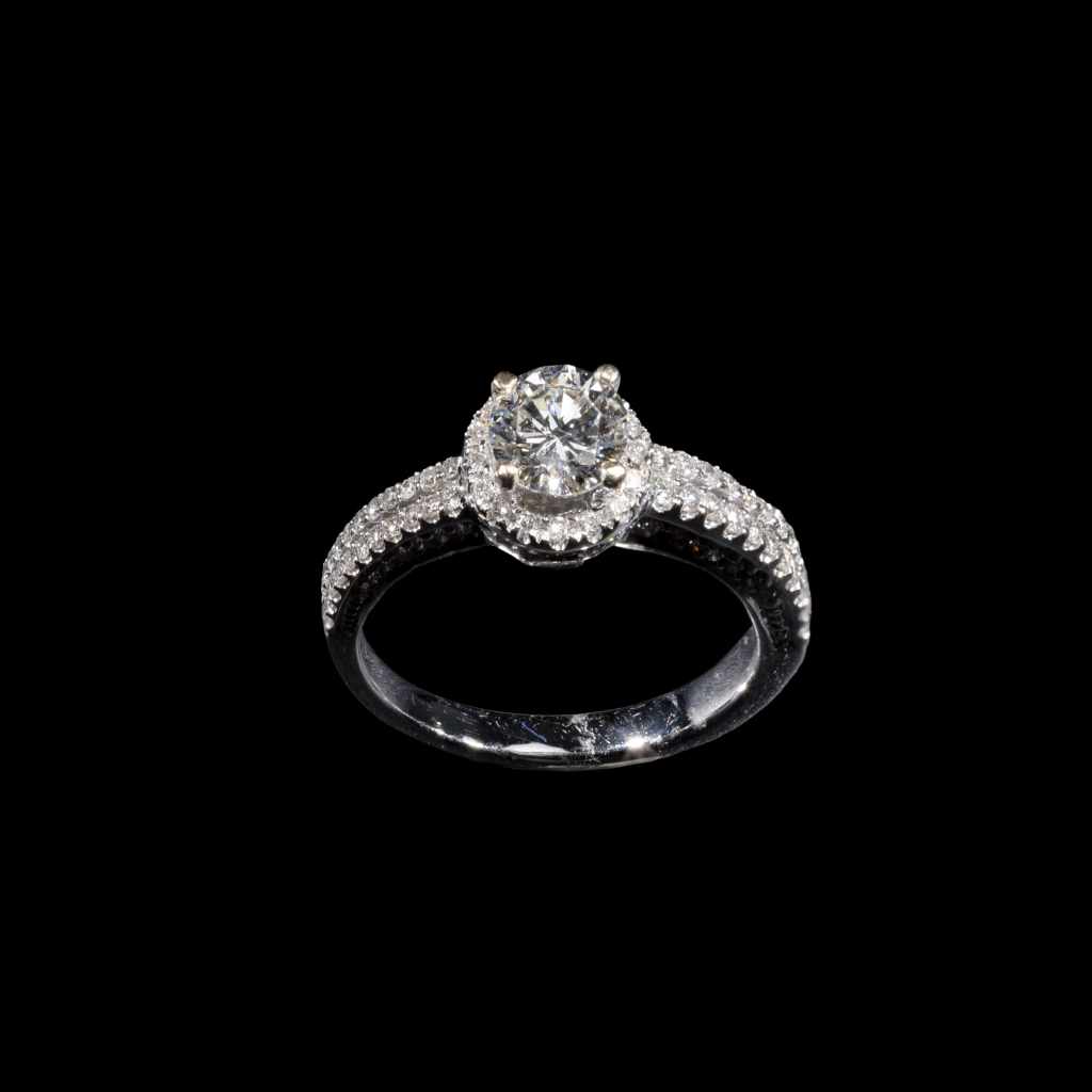 18K white gold halo solitaire ring with round center diamond and pavé diamond accents