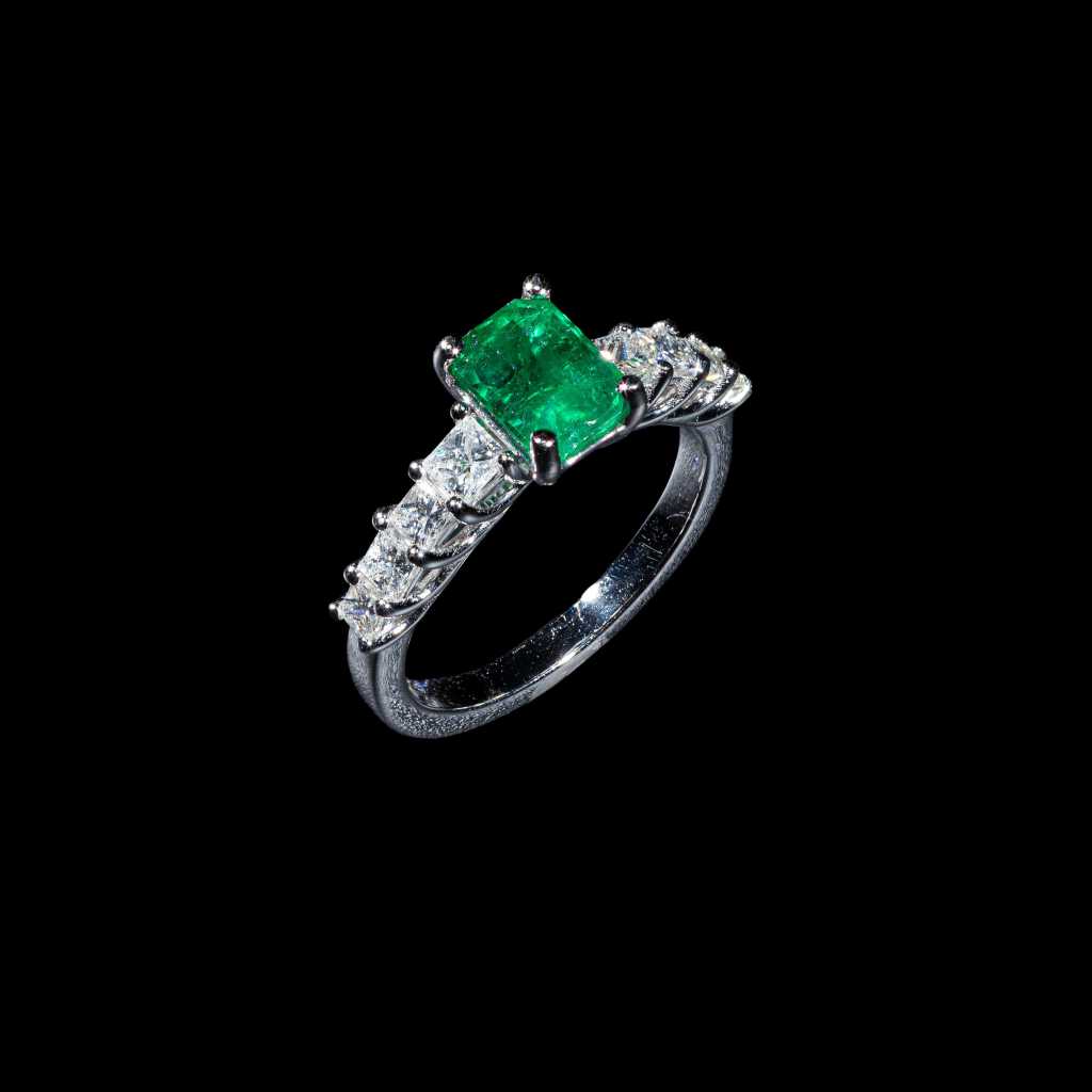 18K white gold Colombian emerald and diamond halo ring with emerald-cut center stone