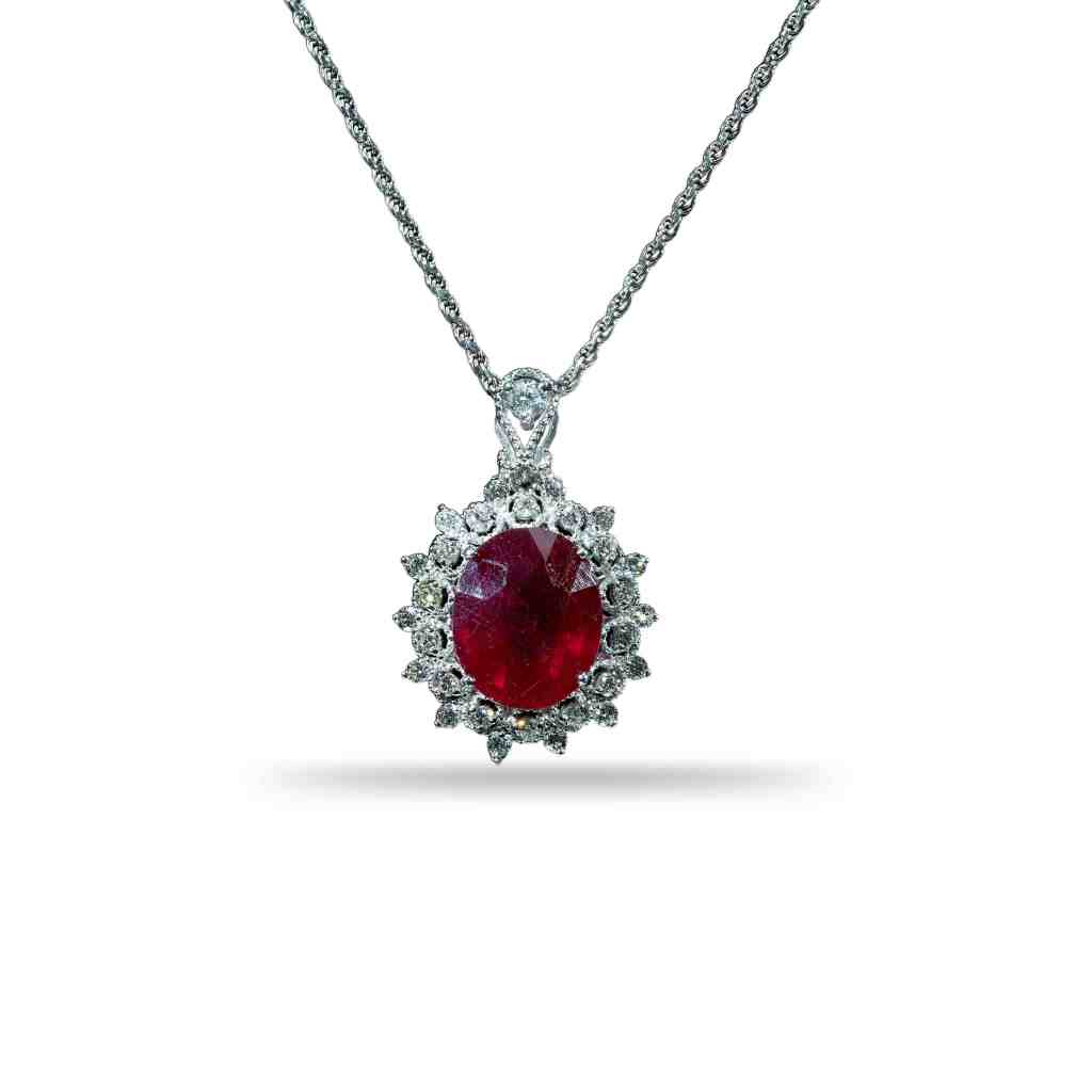 18K white gold pendant necklace featuring a 0.80 ct natural ruby surrounded by a halo of 0.63 ct brilliant-cut natural diamonds on a white gold chain.