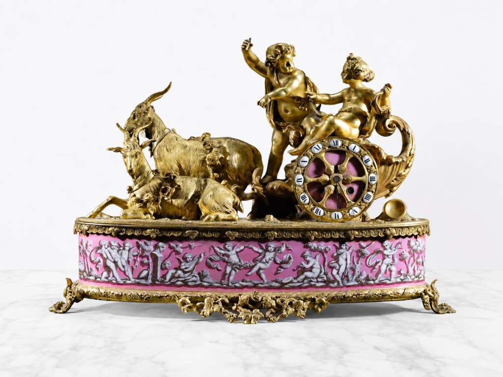 19th-century French bronze and porcelain figural clock with children, goats and carriage scene