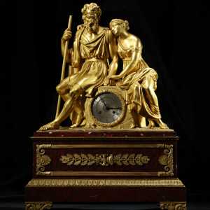 19th-century French gilt-bronze figural mantel clock with classical figures and ornate red base