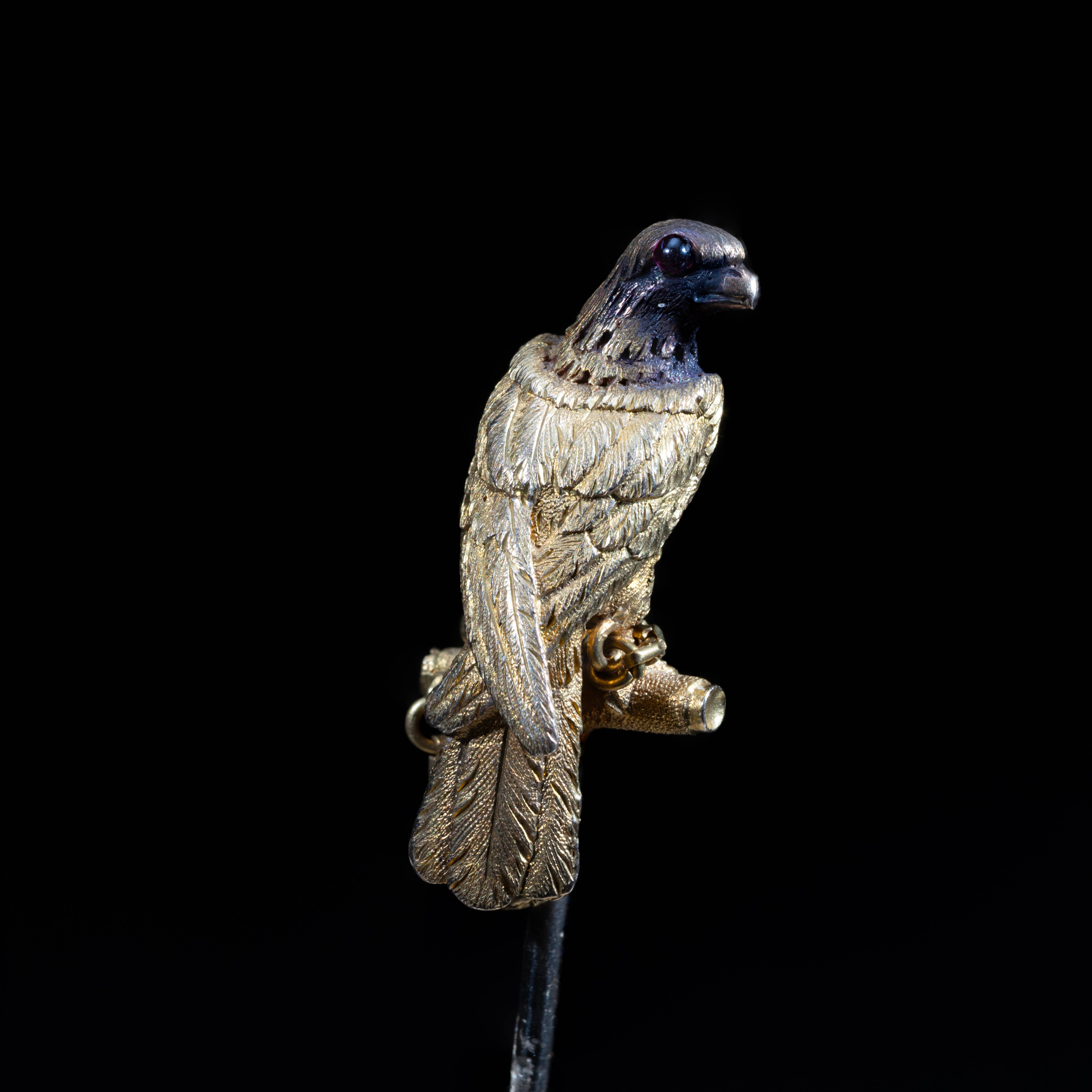 19th-century antique gold falcon brooch with detailed feathers and jeweled eye