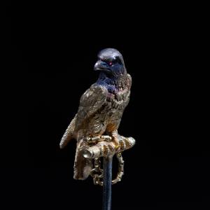 19th-century antique gold falcon brooch with detailed feathers and jeweled eye