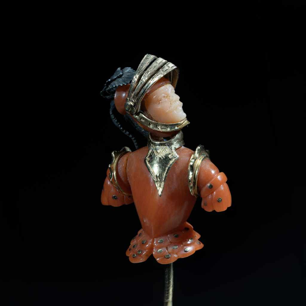 Antique gold and natural coral figural stick pin with intricate sculptural detailing