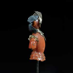 Antique gold and natural coral figural stick pin with intricate sculptural detailing