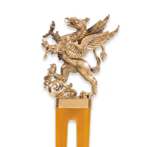 Antique gold winged griffin figural ornament with intricate detailing and jeweled eye