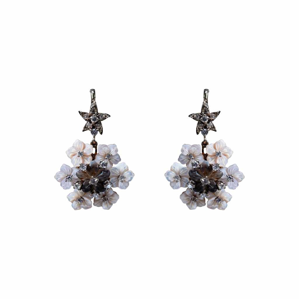18K gold floral earrings featuring carved coral and seashell flowers accented with round diamonds.