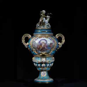 Rare Sèvres turquoise and gilt porcelain vase with hand-painted mythological scene and sculptural child and goat finial