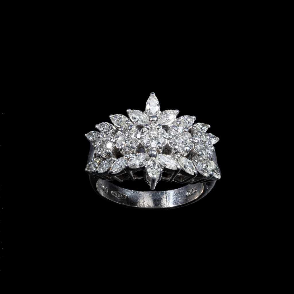 18K white gold floral ring featuring 1.50 carats of marquise diamonds and 0.57 carats of round diamonds.
