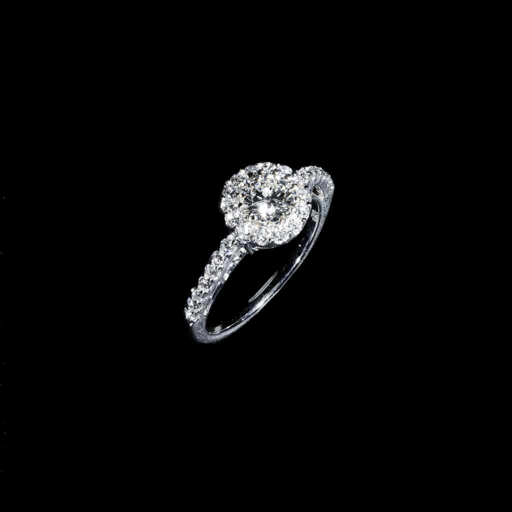 18K white gold halo ring featuring a 0.59 carat round center diamond surrounded by 0.25 carats of accent diamonds.