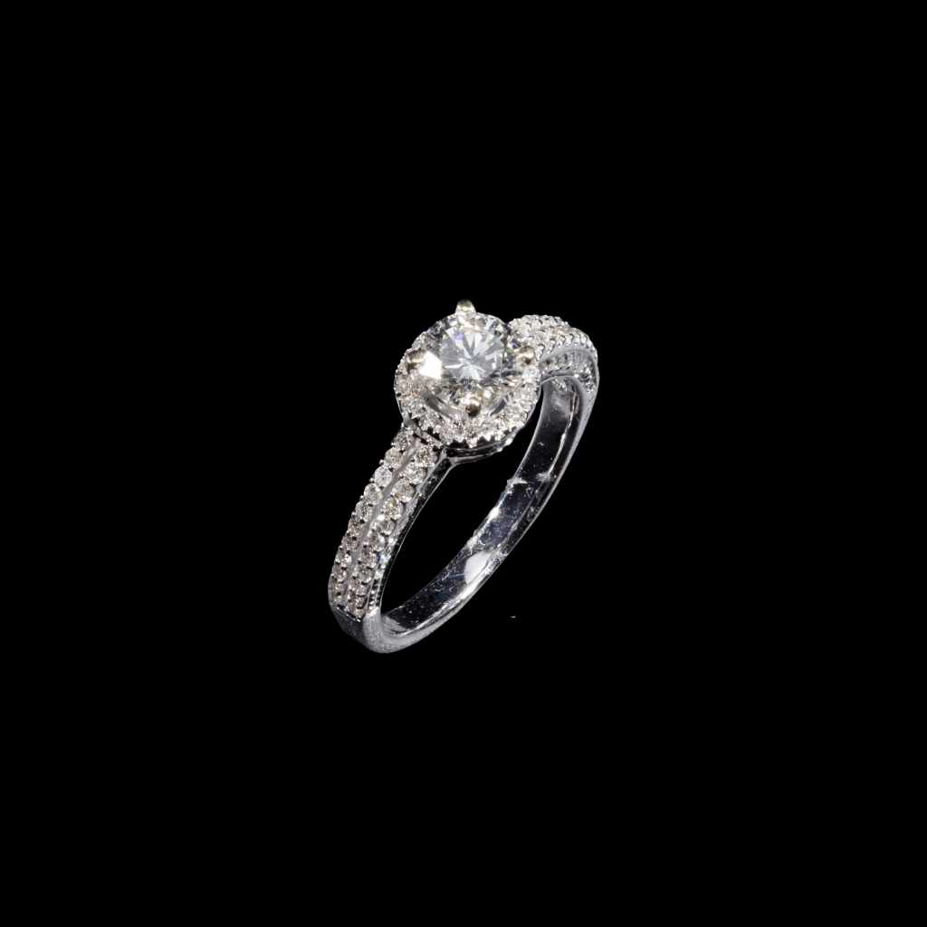 18K white gold halo solitaire ring with round center diamond and pavé diamond accents