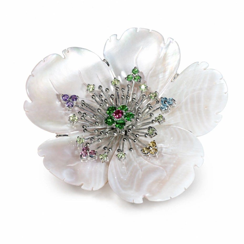 Hand-carved mother-of-pearl flower brooch with vibrant multicolored gemstones and intricate floral detailing