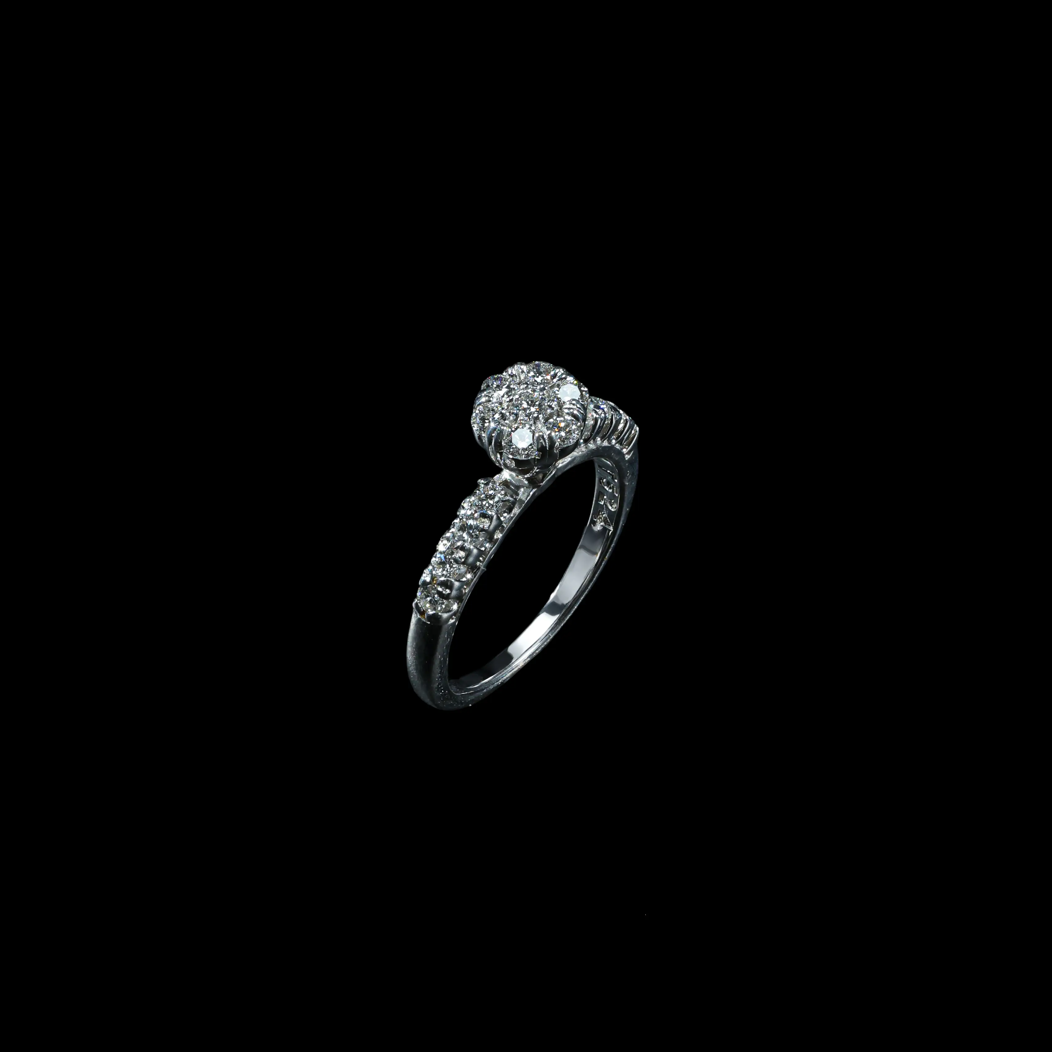 18K white gold diamond floral cluster ring with round brilliant diamonds and diamond-set shoulders.