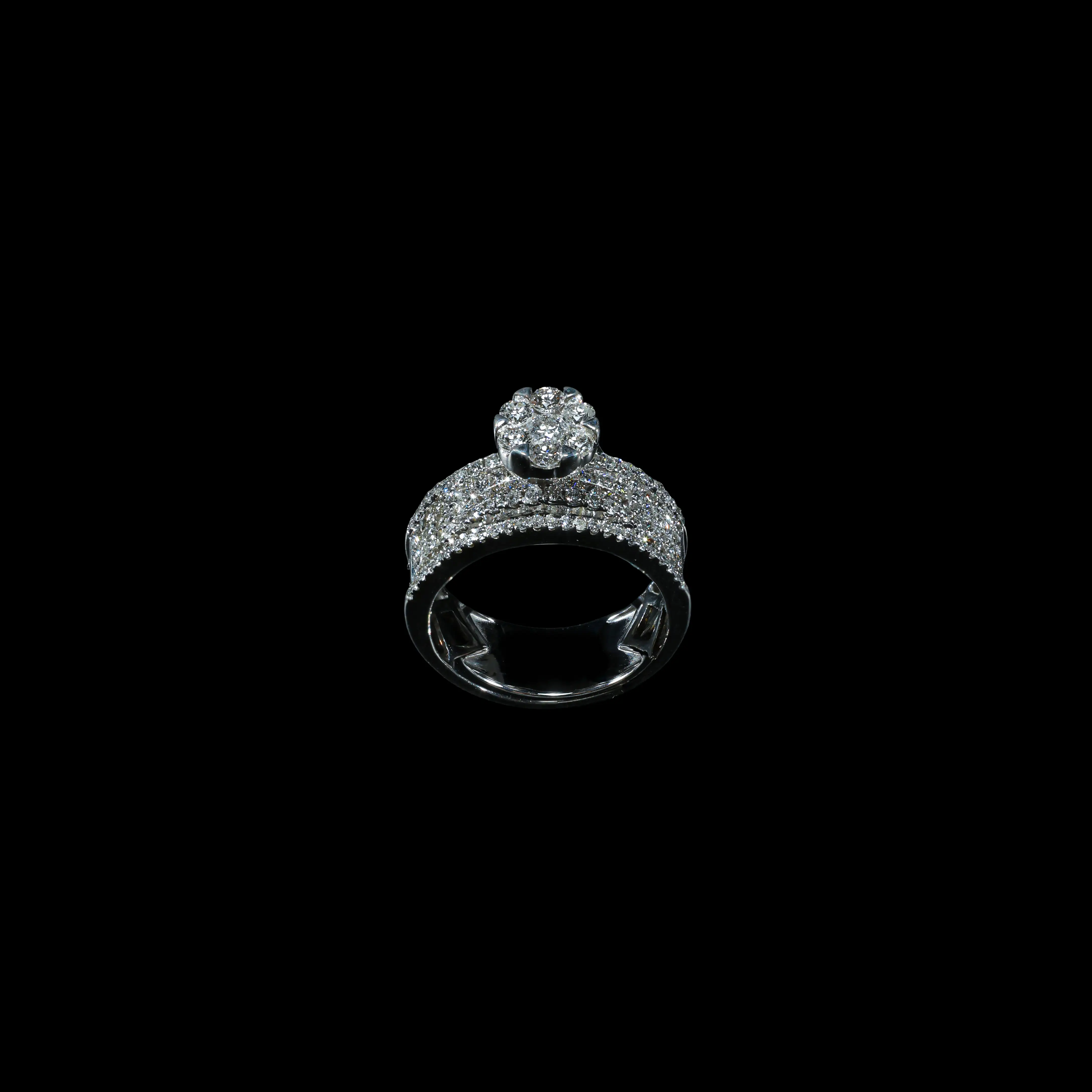 18K white gold statement ring with pavé-set diamonds and raised seven-diamond floral cluster.