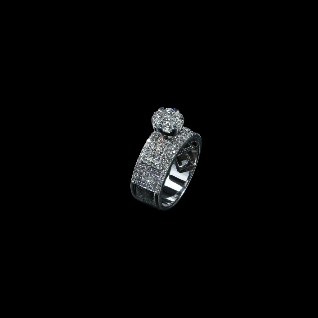 18K white gold statement ring with pavé-set diamonds and raised seven-diamond floral cluster.