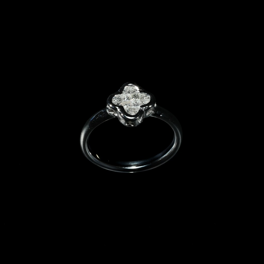 18K white gold cluster ring set with princess-cut diamonds in a floral-inspired design.