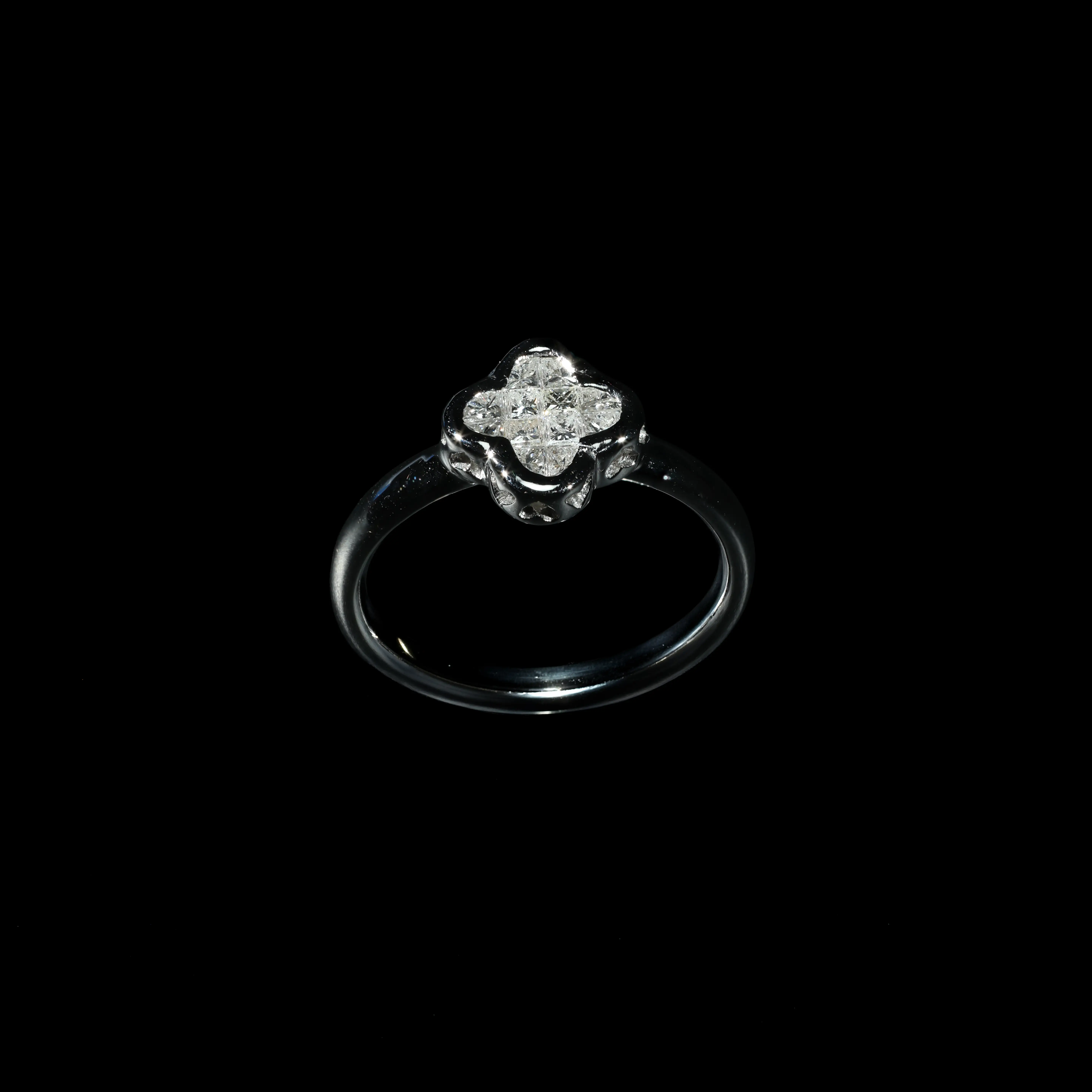 18K white gold cluster ring set with princess-cut diamonds in a floral-inspired design.