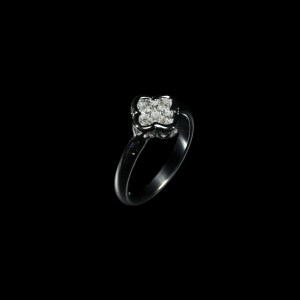 18K white gold cluster ring set with princess-cut diamonds in a floral-inspired design.