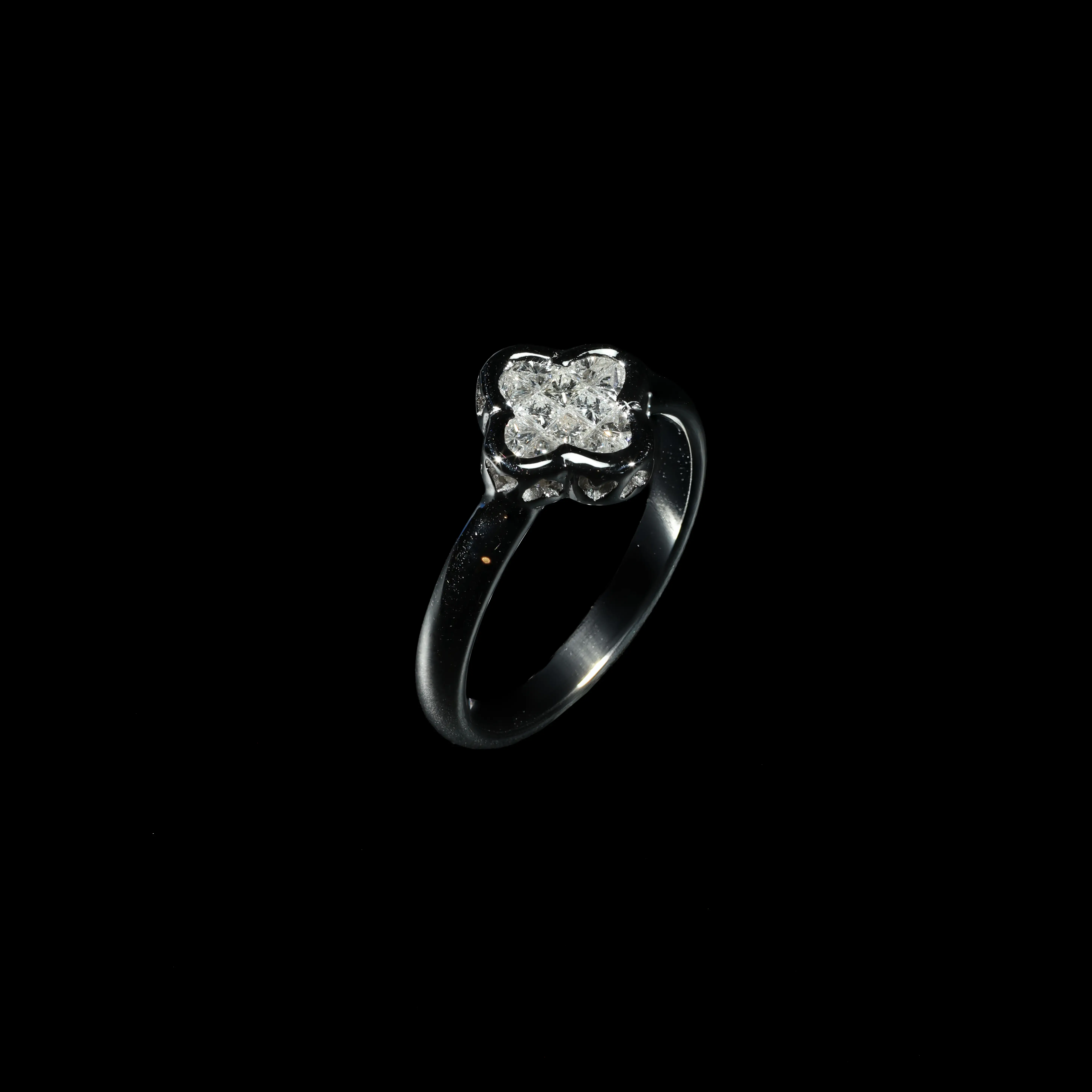 18K white gold cluster ring set with princess-cut diamonds in a floral-inspired design.