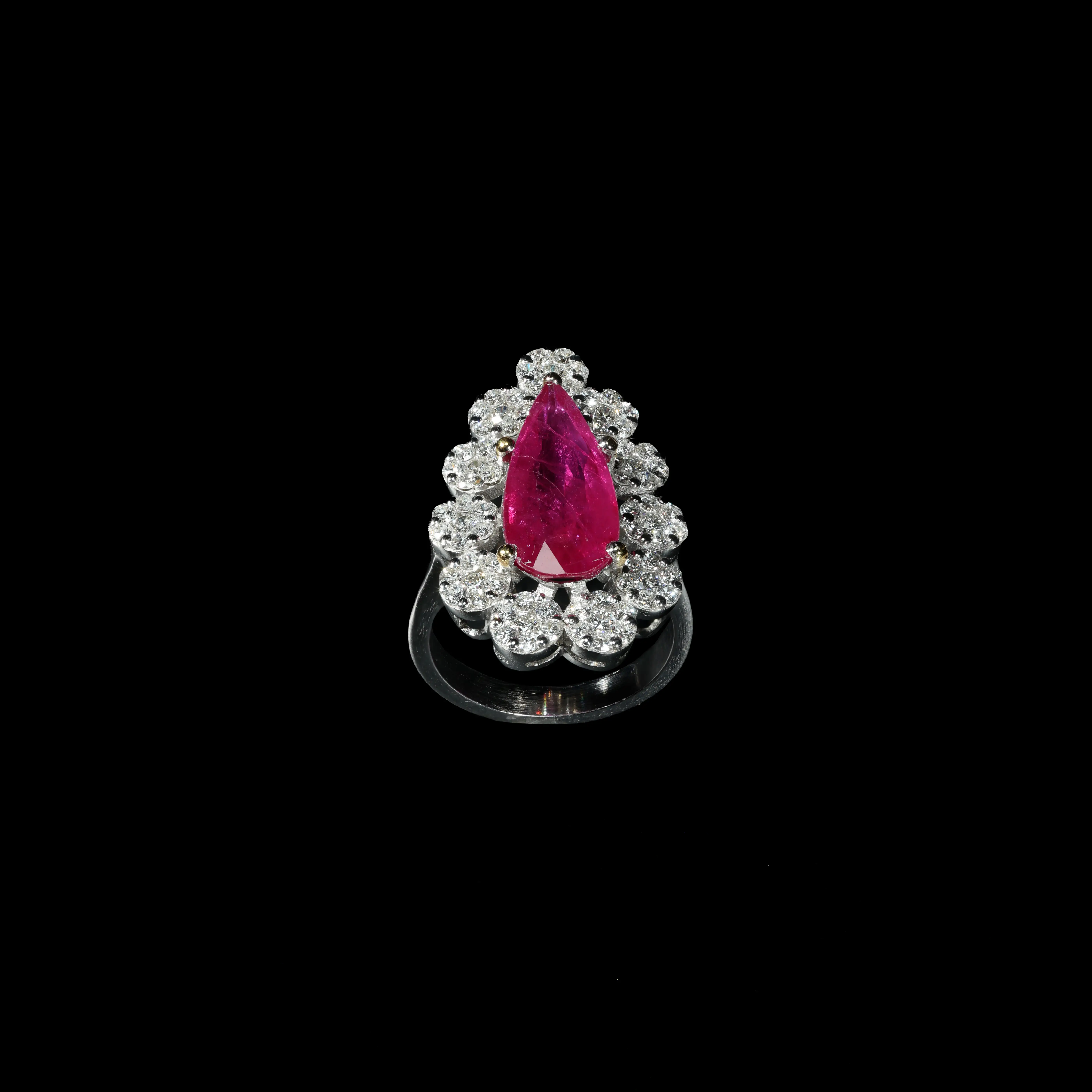 18K white gold ring with pear-shaped ruby and brilliant diamond halo.