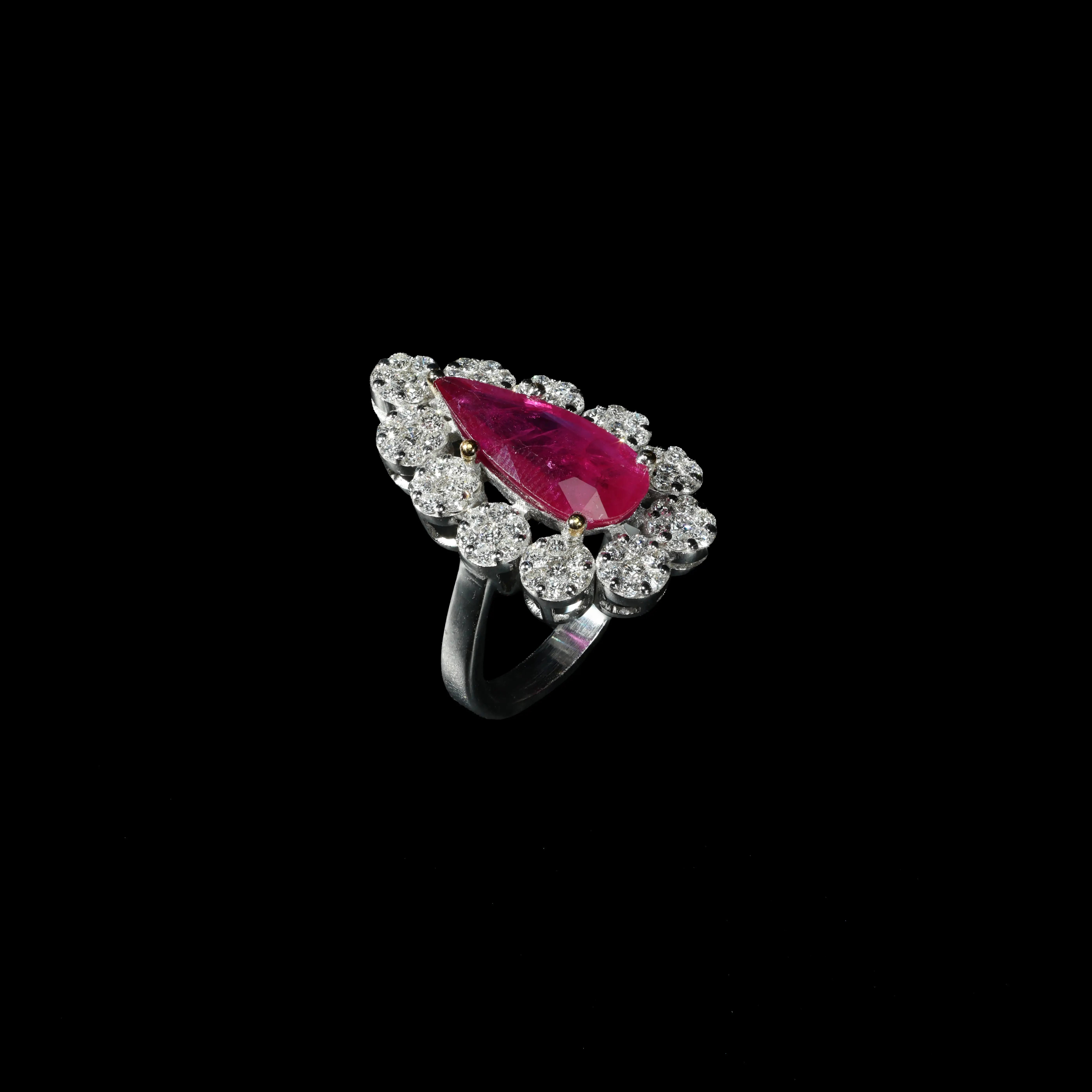 18K white gold ring with pear-shaped ruby and brilliant diamond halo.